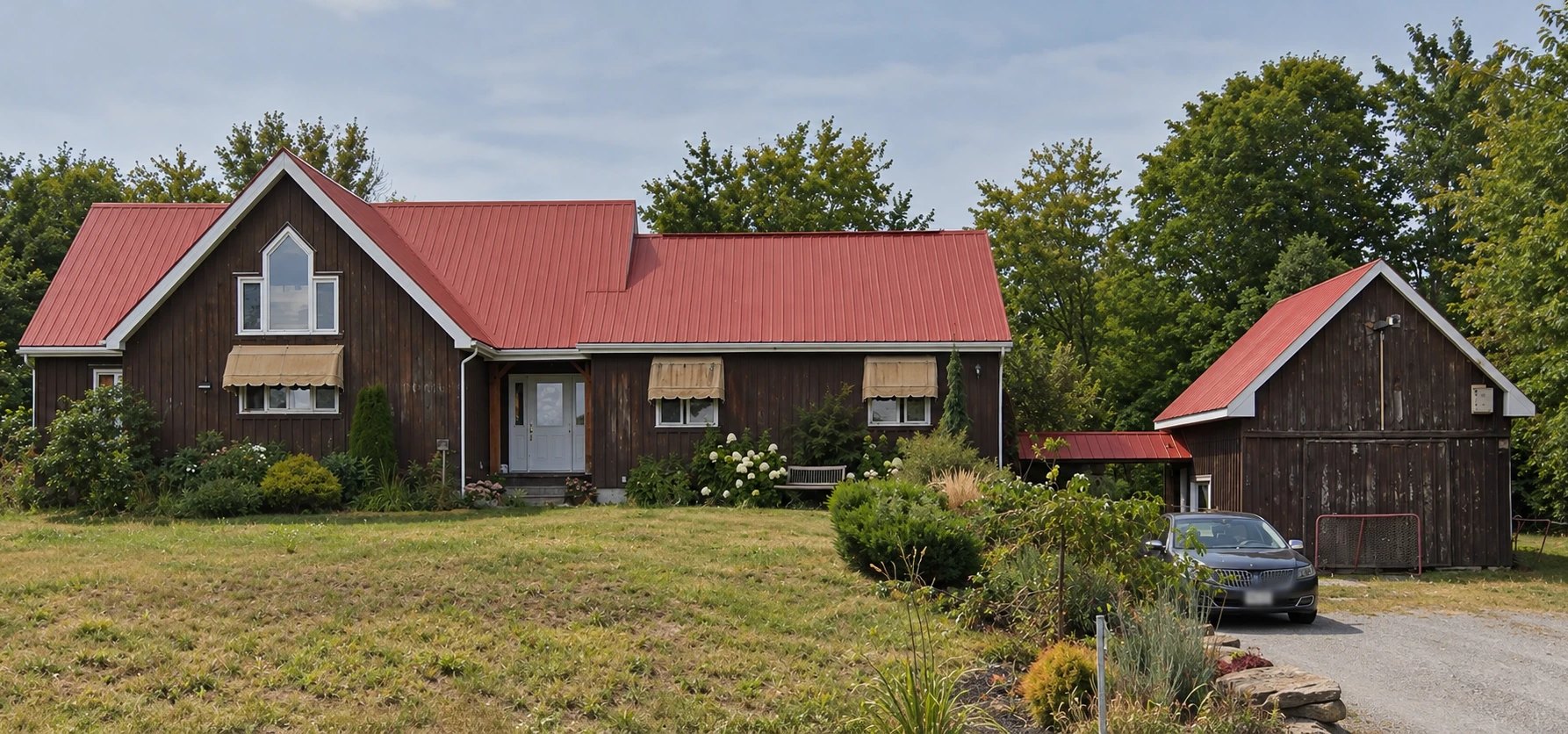 Before: same house with weathered stain and faded trim